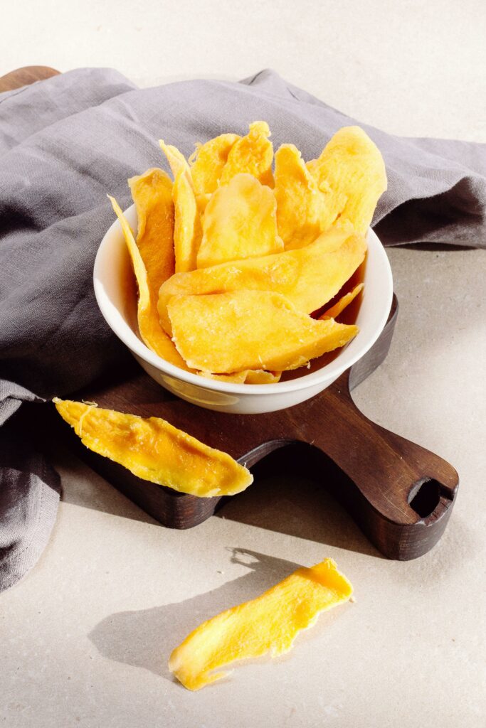 pexels photo 4499212 4499212 Bright and tasty homemade mango chips in a bowl, perfect for a healthy snack.